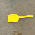 Toy shovel on shallow water